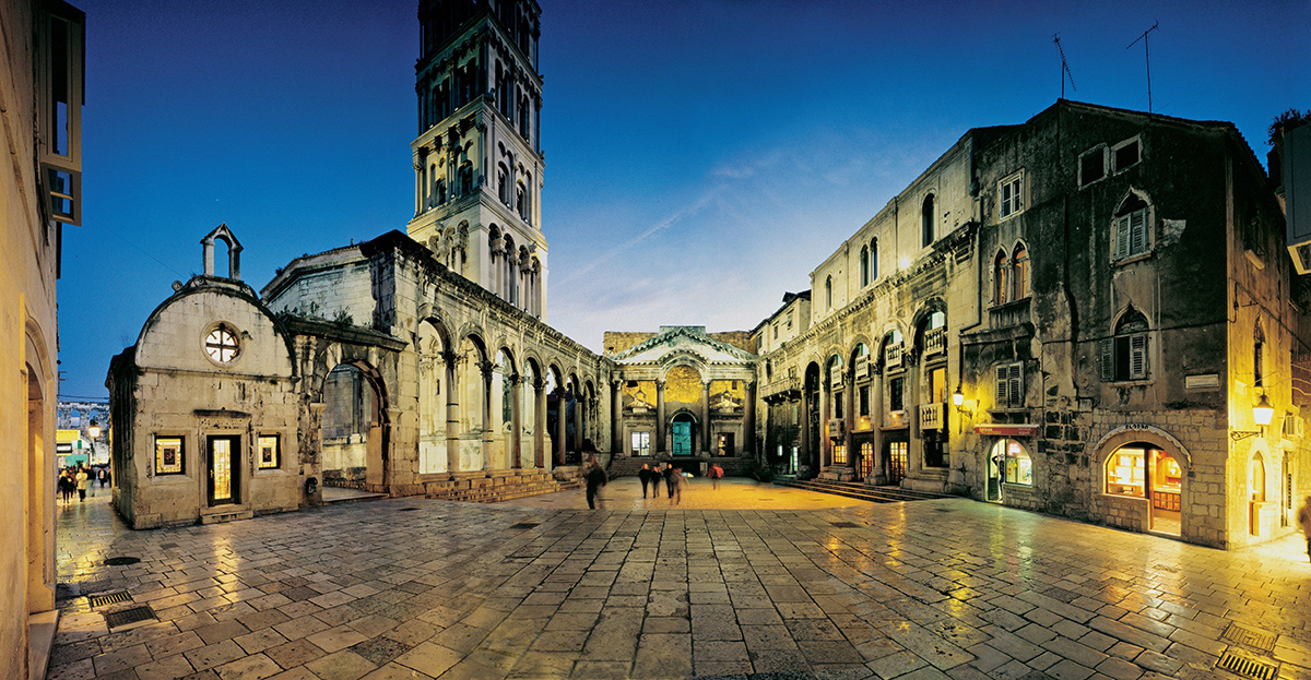city street by night with a cathedral