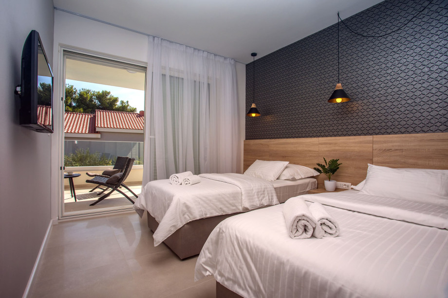 Bedroom No. 2 with two single beds with en-suite and exit to terrace