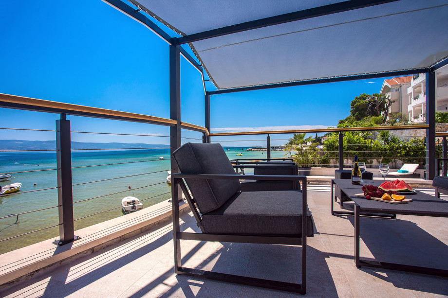 Outdoor sitting area in shadow with open sea view
