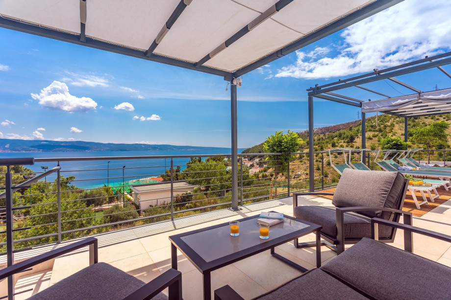 terrace with lounge with sea and pool views
