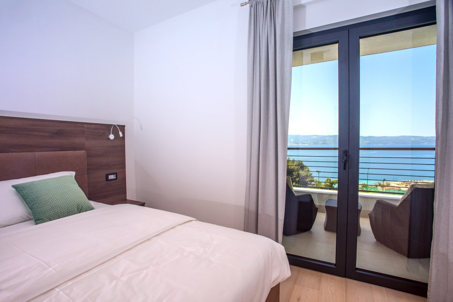 sofa bed, TV and a terrace with sea and pool views