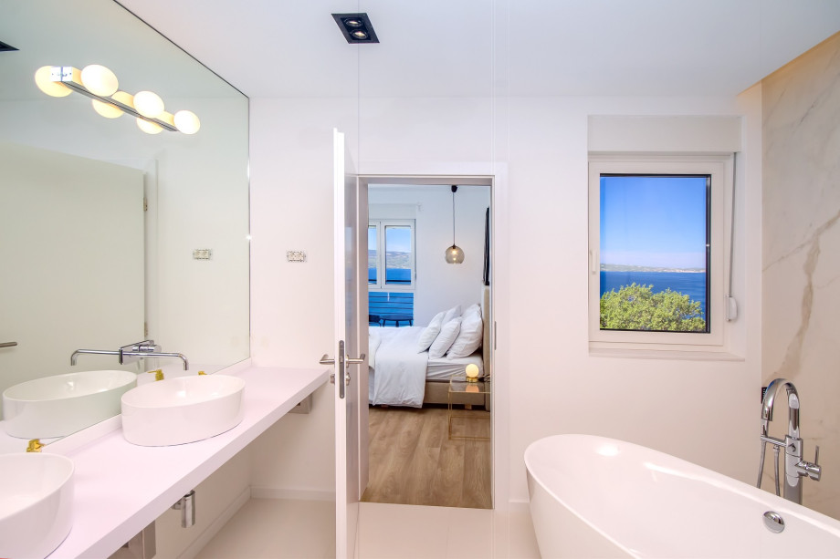 Bathroom in bedroom No.1 with double sink, bath and shower