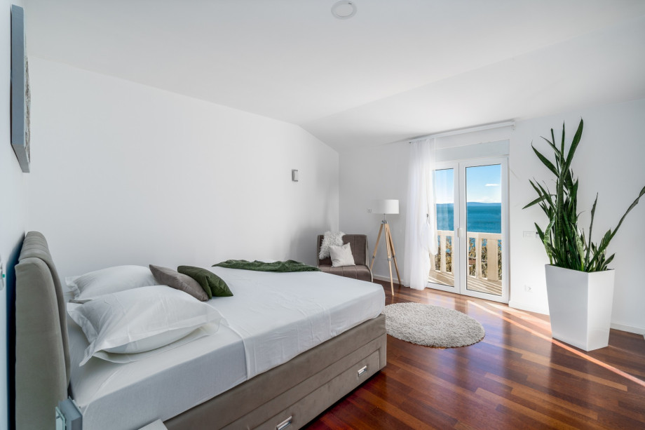 Bedroom No3 with a King size bed, a sofa for 1 person, a balcony with a sea view