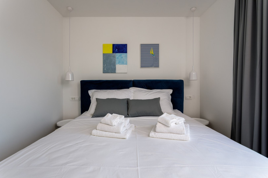 Bedroom No1 with a king size bed 180cm x 200cm, air conditioner, a TV and views on hills.