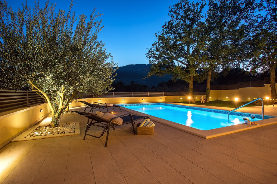 Pool area by night with great lights and view on the mountains