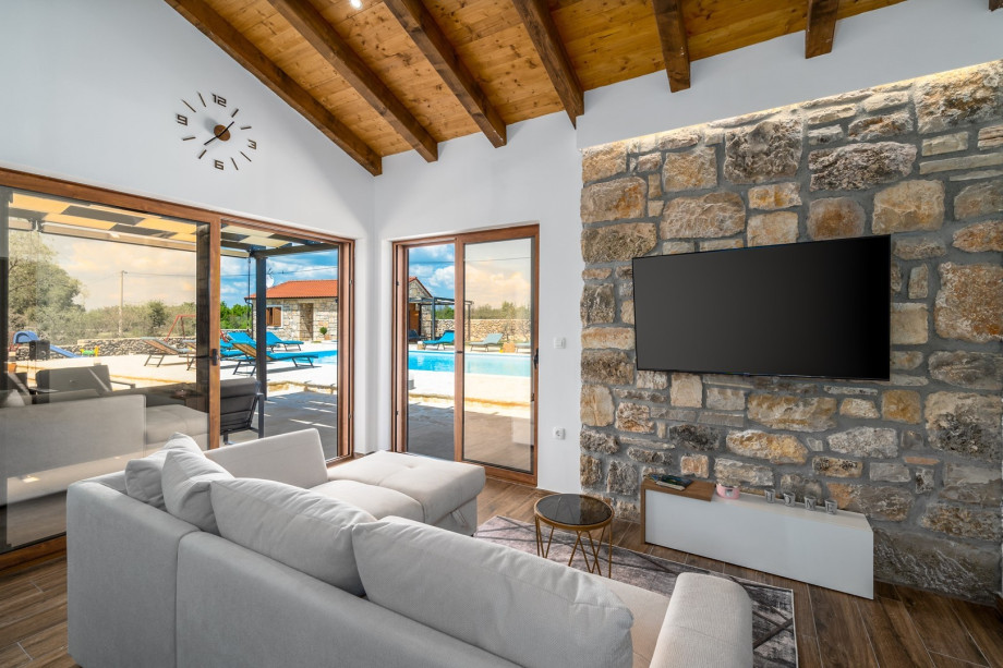 A spacious living room with A/C, TV, Sofa