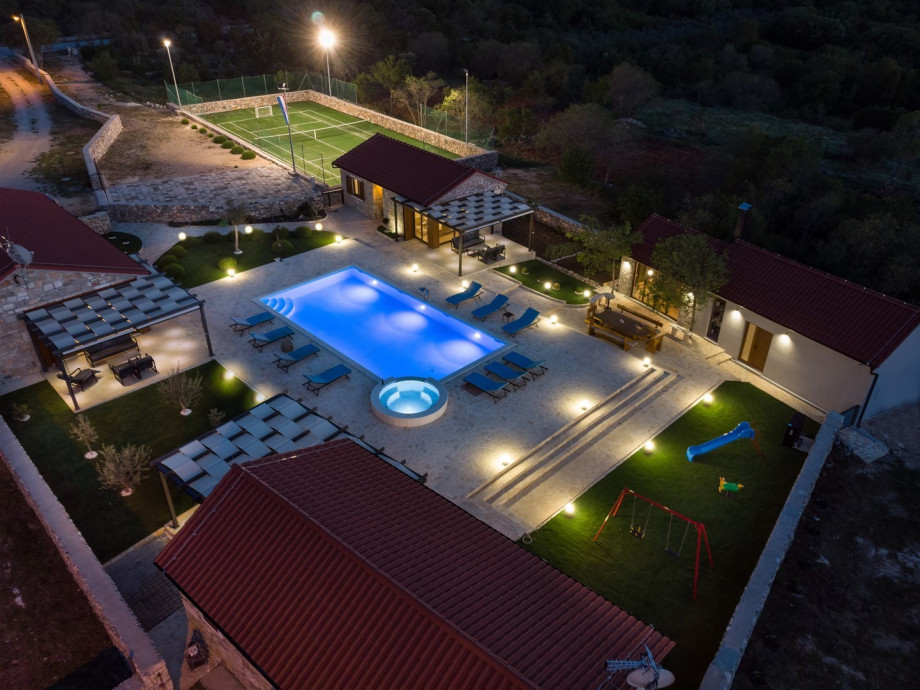A summer kitchen (25sqm) with traditional barbecue, a round roasting electrical oven