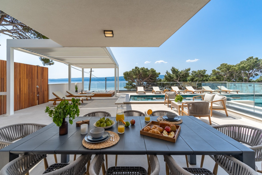 The outdoor offers a covered dining area with a barbecue and direct entrance to the living area