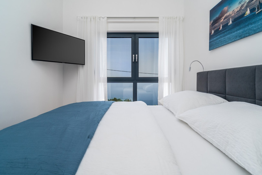 Air-conditioning, a TV and open sea and island views