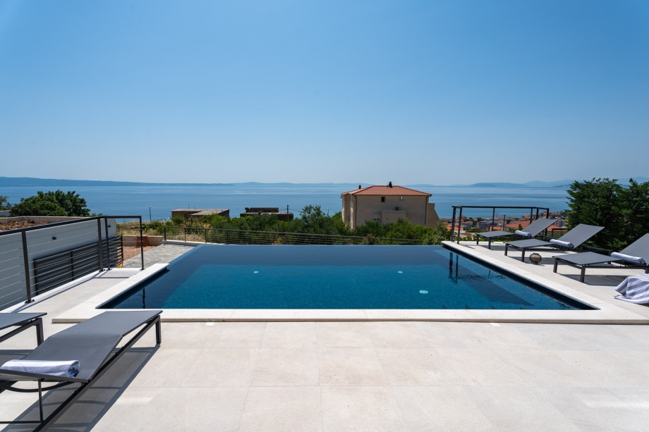 A private, heated infinity 32 sqm (8m x 4m) swimming pool with a fully automated salt electrolysis system