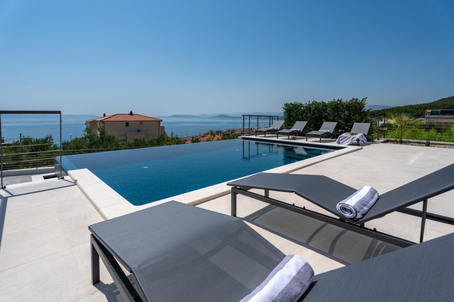 A private, heated infinity 32 sqm (8m x 4m) swimming pool with a fully automated salt electrolysis system