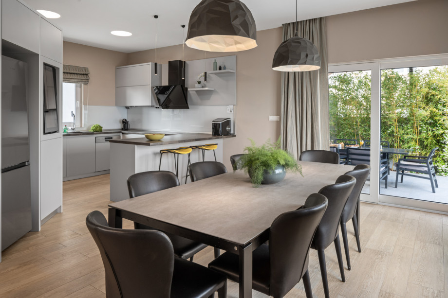 Comfortable dining area for 8 people with an exit to the outdoor dining area and pool