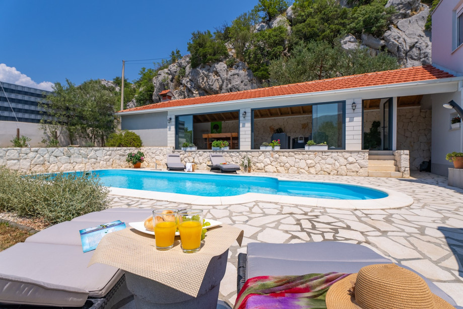 Sun deck area with 4 deck chairs and private pool