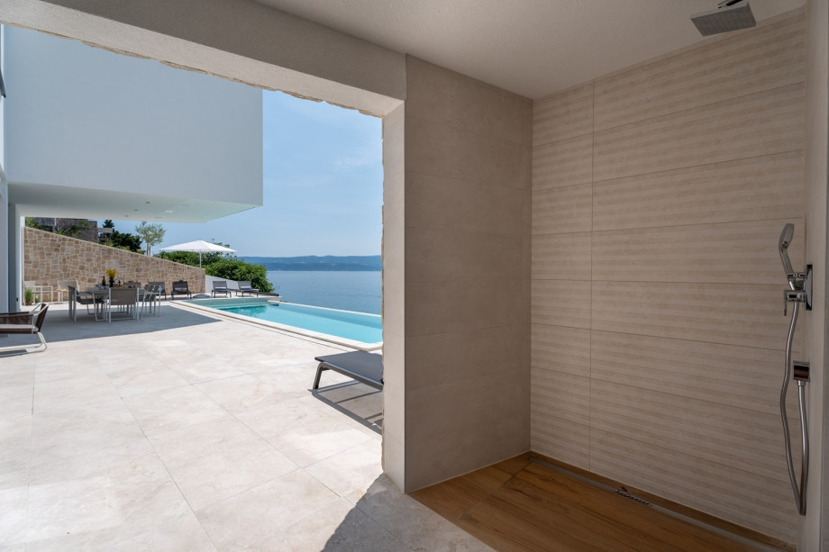 The sunbathing area with 10 deck chairs, outdoor shower, a separate toilet