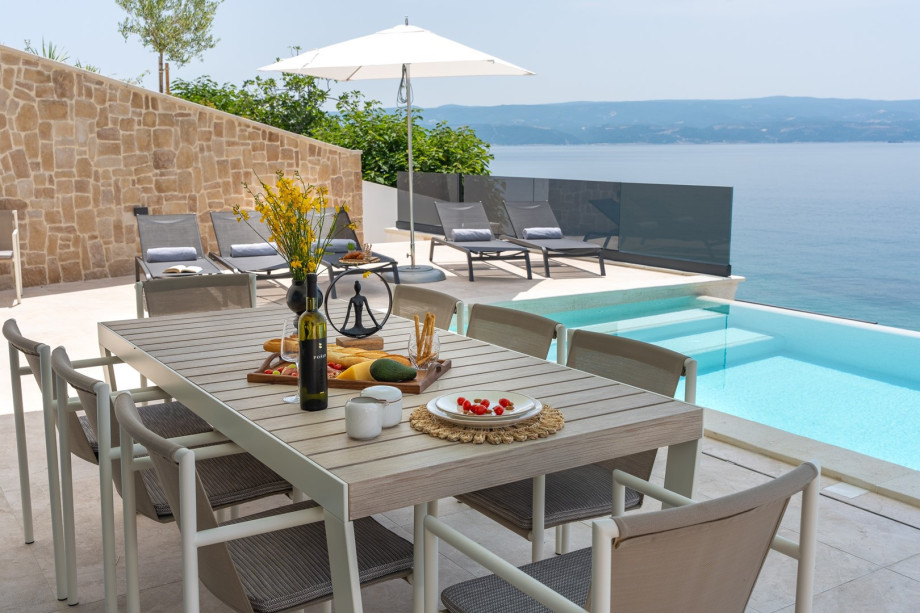 Covered outdoor dining area with a traditional barbecue for maximum relaxation and enjoying the Mediterranean climate