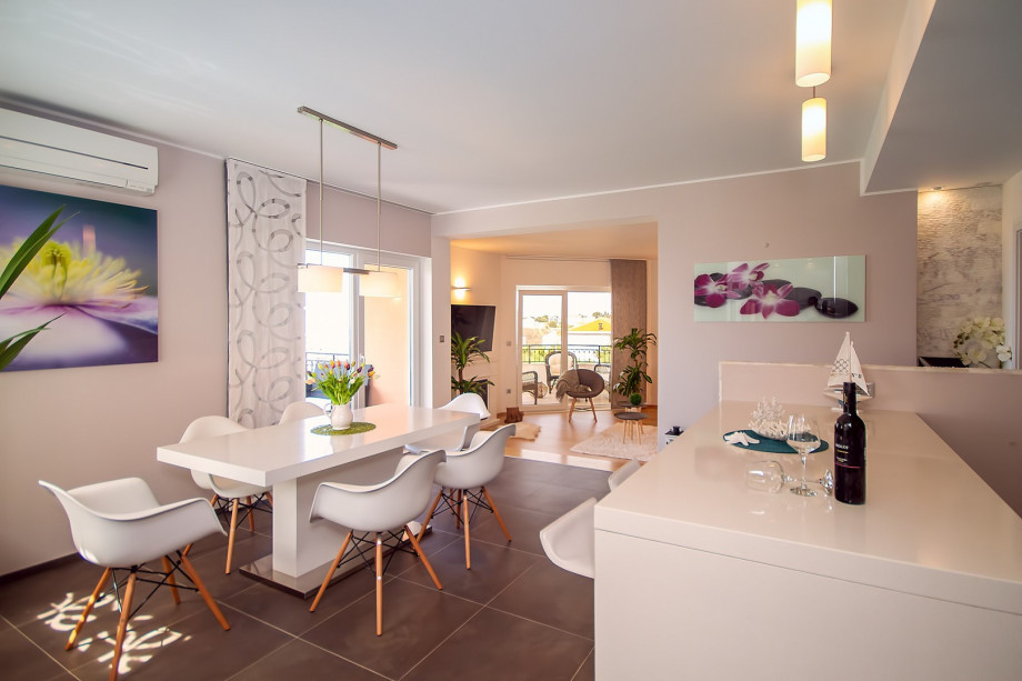 air-conditioned living and dining area with a fully equipped kitchen