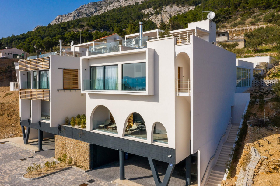 Villa Bura is settled on a land plot of 956 sqm and offers a total of 556 sqm living space. It has 3 levels connected by staircase and elevator.