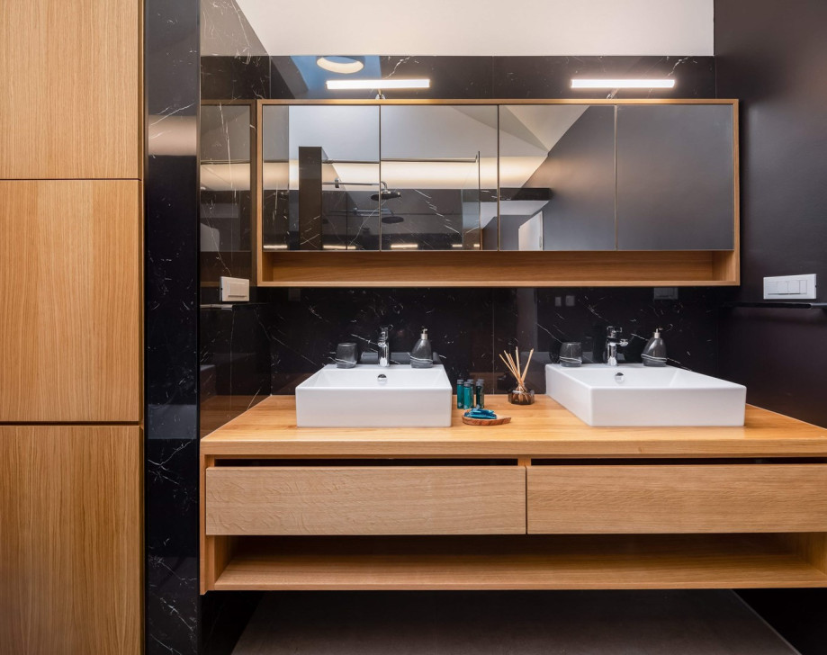 An en-suite bathroom with a bathtub and a shower, a double sink, a toilet, and a bidet.