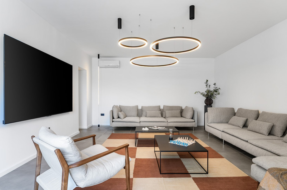 Spacious living room adorned with  massive flat-screen TV