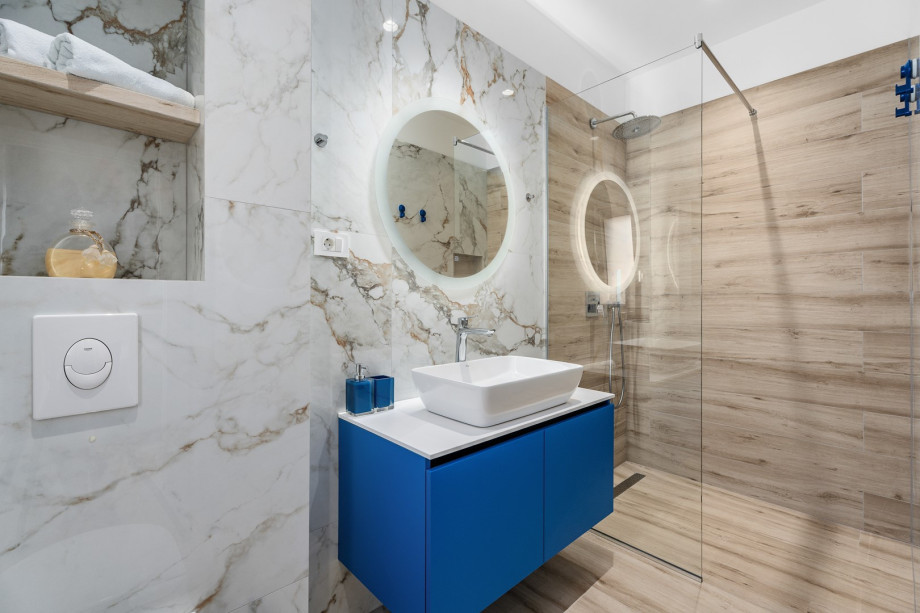 An en-suite bathroom with a shower, a sink, and a toilet