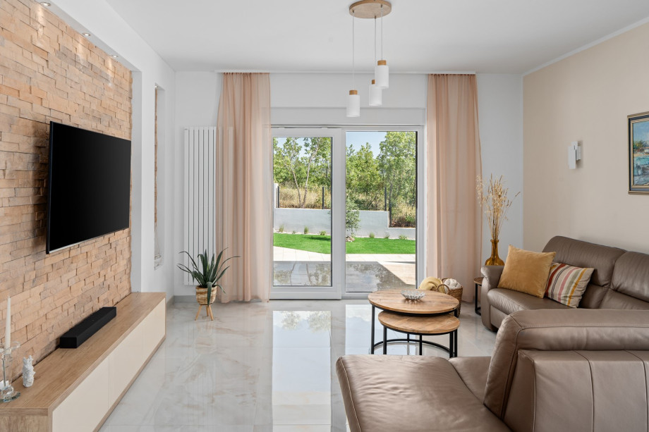 A bright and open-plan living area, fully air-conditioned and filled with natural light, with direct access to the pool terrace