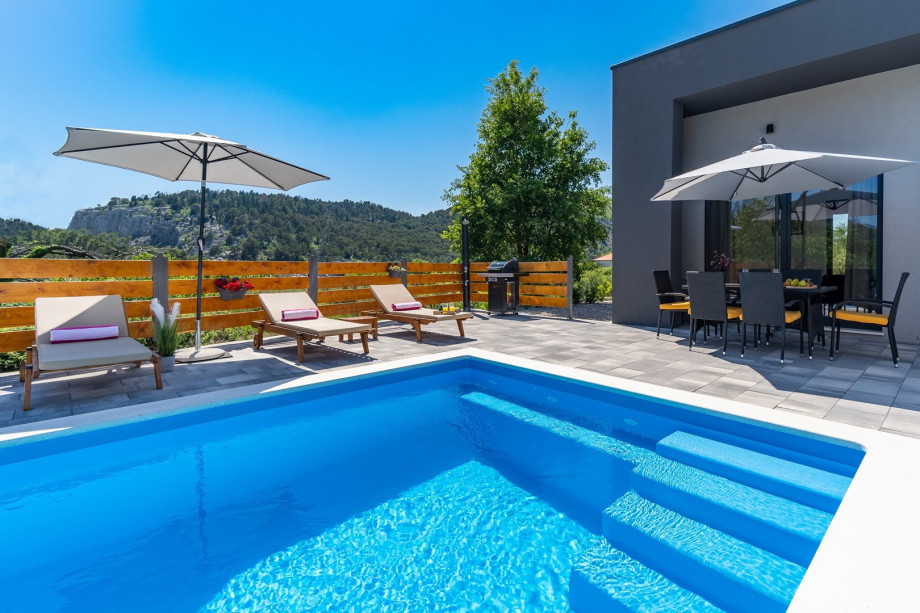 Private swimming pool with 6 deck chairs, outdoor dinning area with BBQ