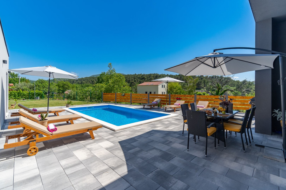 Private swimming pool with 6 deck chairs, outdoor dinning area with BBQ
