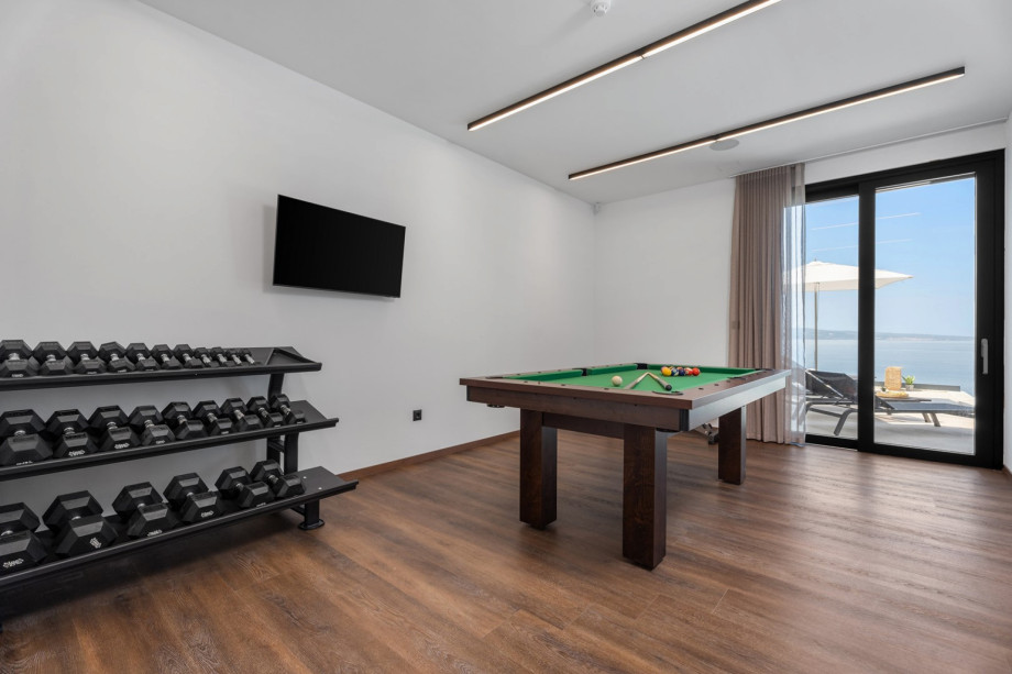 Air-conditioned Gym (22sqm) with a Multipurpose machine, an exercise bike, a Billiard for some fun, a TV, a spacious Finnish sauna, and a shower next to it.