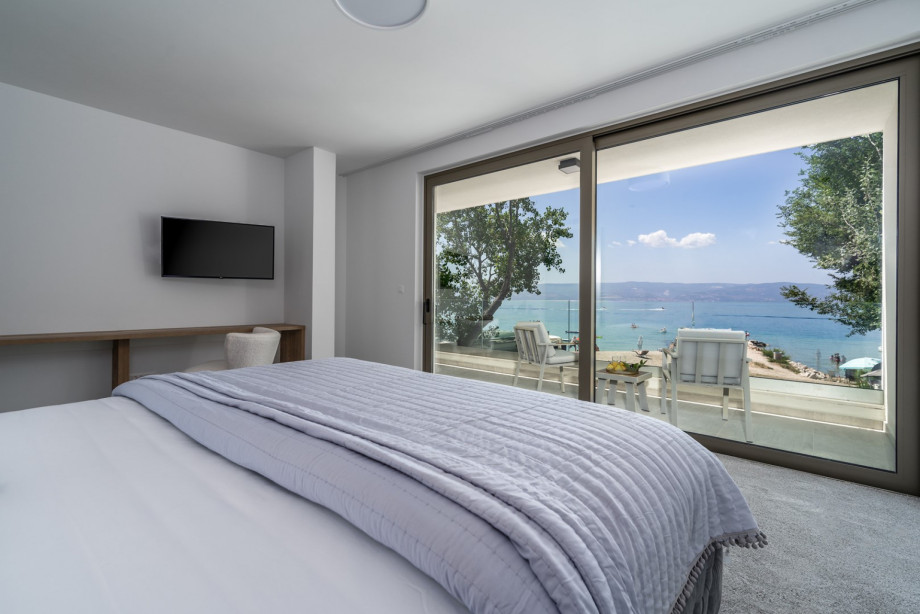 Bedroom No2 (South, 26sqm) offering amazing sea and pool views, with a King size bed 200cm x 200cm, a TV