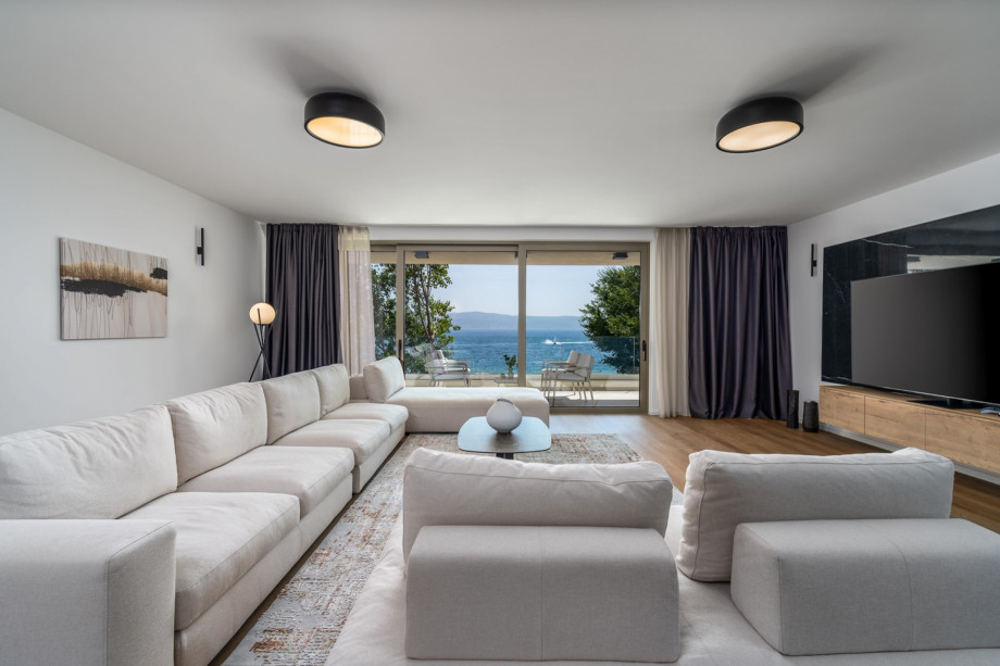 Spacious living room 63 sqm South oriented with comfortable and stylish sofas, a huge flat-screen TV, and Play Station 5
