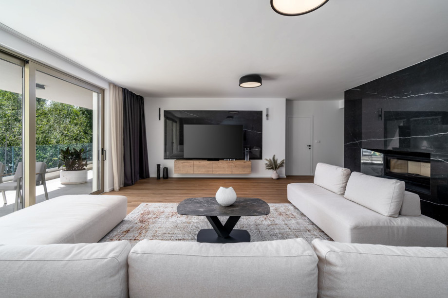 Spacious living room 63 sqm South oriented with comfortable and stylish sofas, a huge flat-screen TV, and Play Station 5