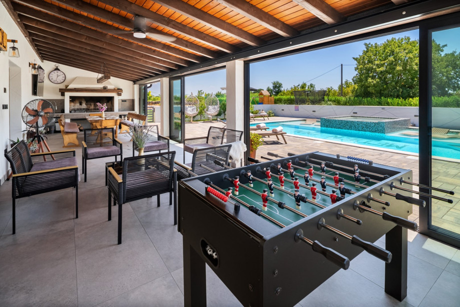 One of the lounge areas with football a table