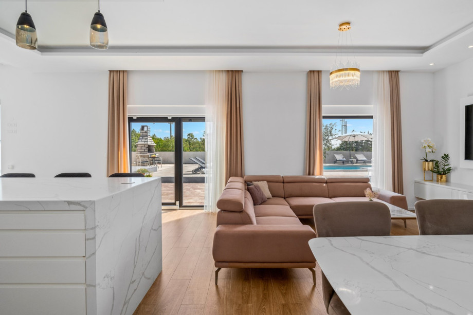 Living room with exit to pool area, all is air - conditioned