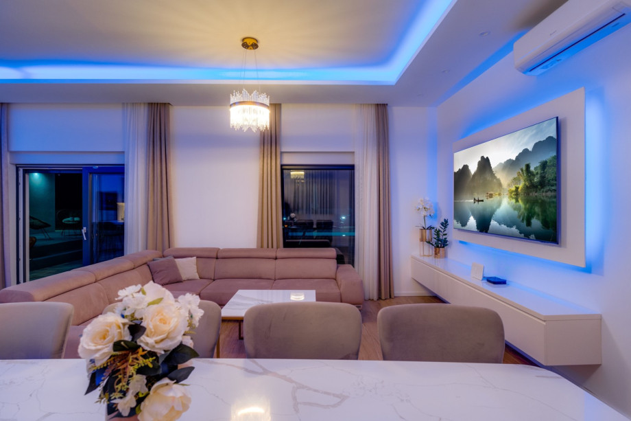 Living room with a sofa, flat-screen TV, all air conditioned