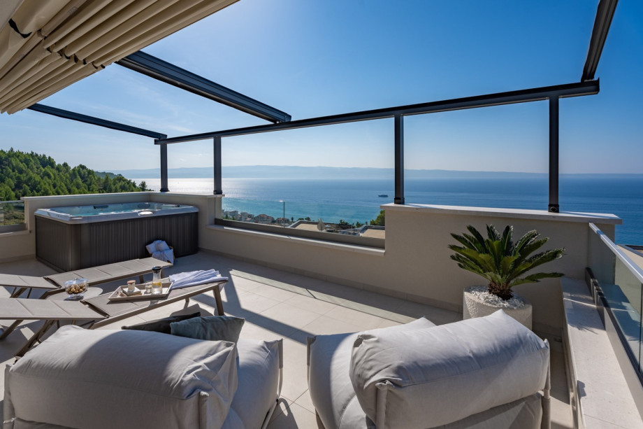 The Rooftop outdoors with two lounge chairs and two deck chairs