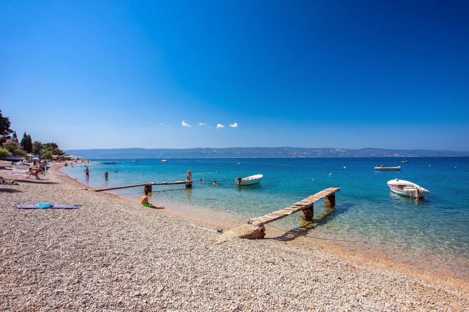 Pebble beaches in Stanići with crystal clear sea and natural shadow