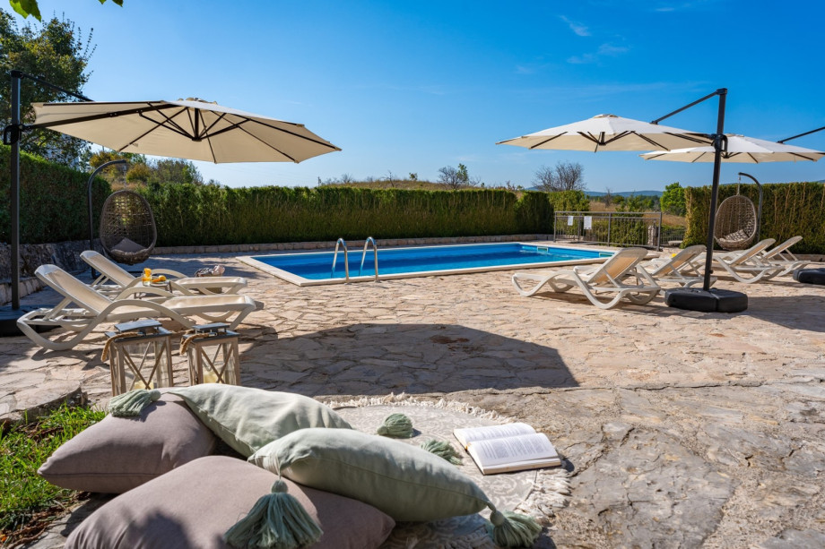 Spacious sun deck area with 8 deck chairs, 3 sun umbrellas