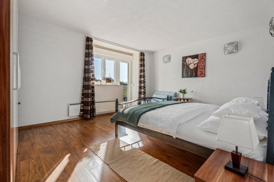 A Bedroom NO2  with a king size bed, a sofa (can convert into a sofa bed for one person), A/C, and a balcony with pool views