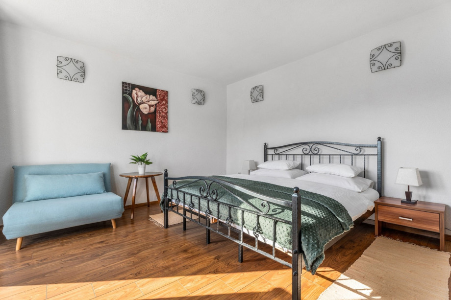 A Bedroom NO2  with a king size bed, a sofa (can convert into a sofa bed for one person), A/C, and a balcony with pool views