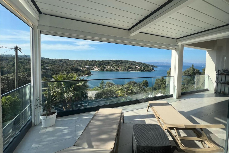 Newly roofed, modern balcony on the first floor provides a stunning view of a peaceful bay surrounded by lush greenery.
