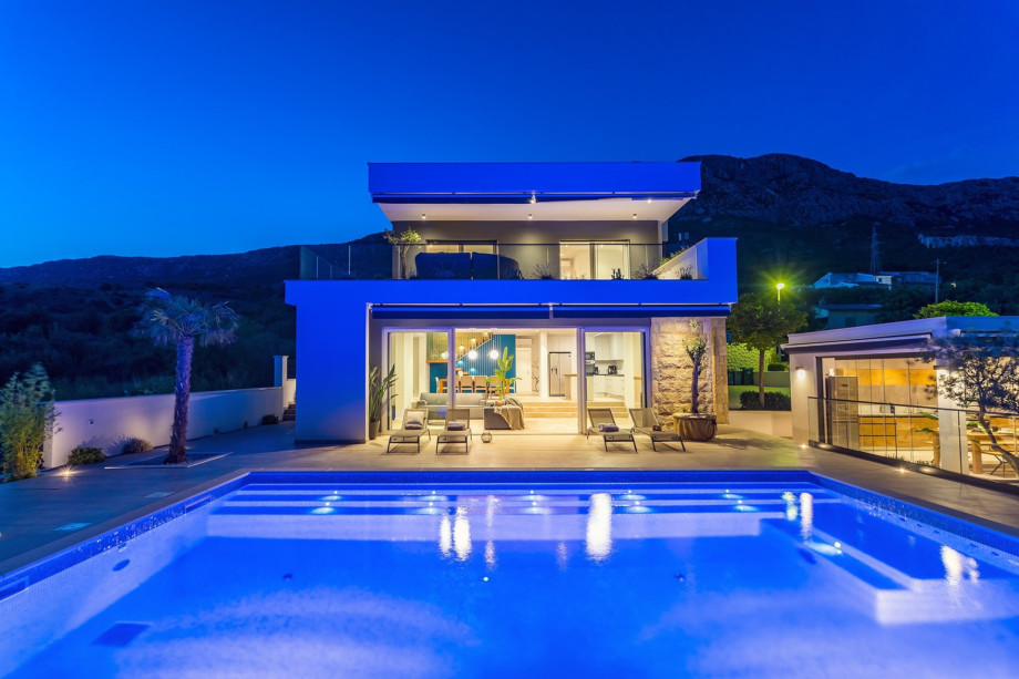 The outdoor area offers a heated private pool, jacuzzi, and a huge sun deck