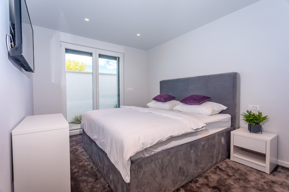 Bedroom No1 with a king-size bed 180cmx200cm, A/C, TV and exit to the terrace.