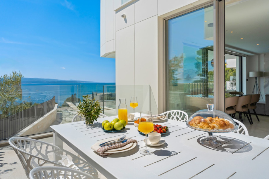 An outdoor dining area with a barbecue (gas). which you can approach directly from the kitchen