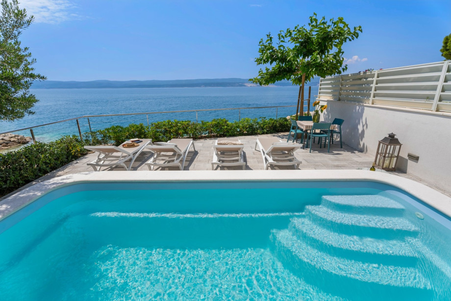 The sun deck area with 4 deck chairs and sun-umbrella, and a coffee table with 6 chairs if you want to have a perfect spot.