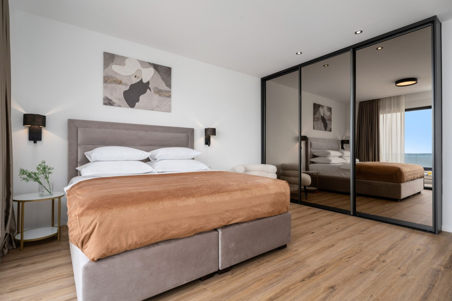 Bedroom NO1 (20sqm) with a king size bed 180cm x 200cm, a sofa, A/C, a TV