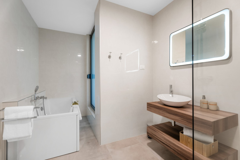 A family restroom featuring a shower and bathtub.