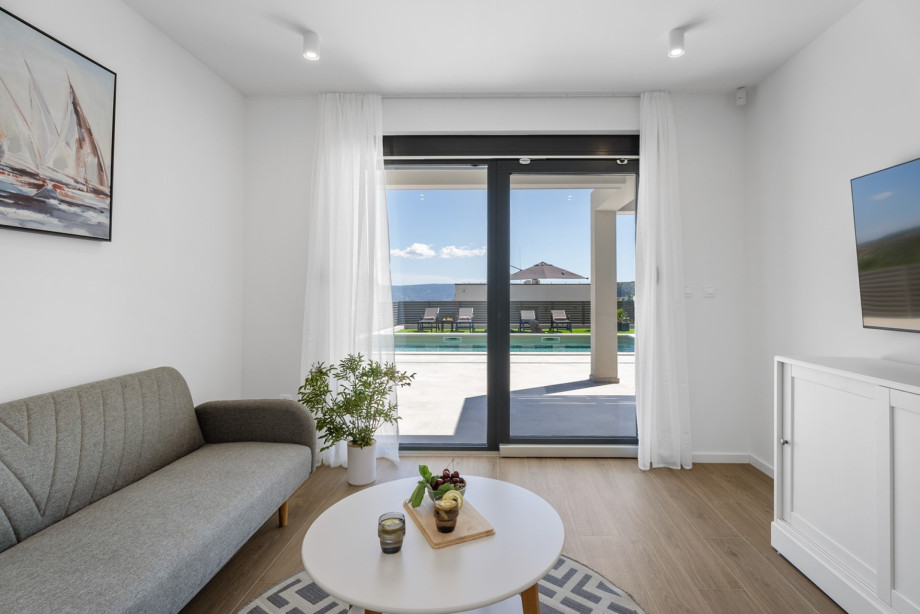 The second living room on the ground floor with a TV, air conditioning