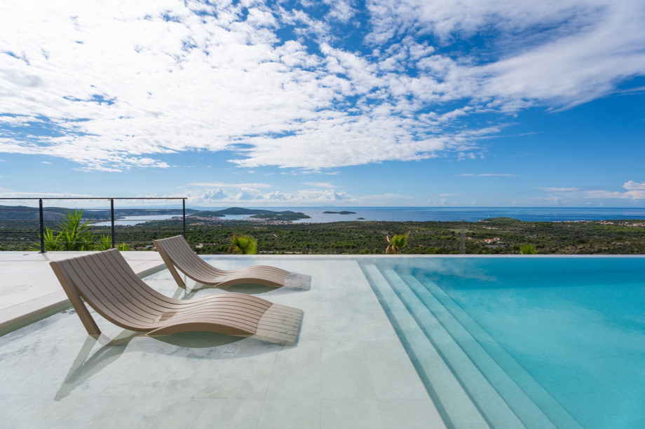 The 470 square meter interior is divided into two levels, with the main platou providing a view of a 6.700 square meter private plot.