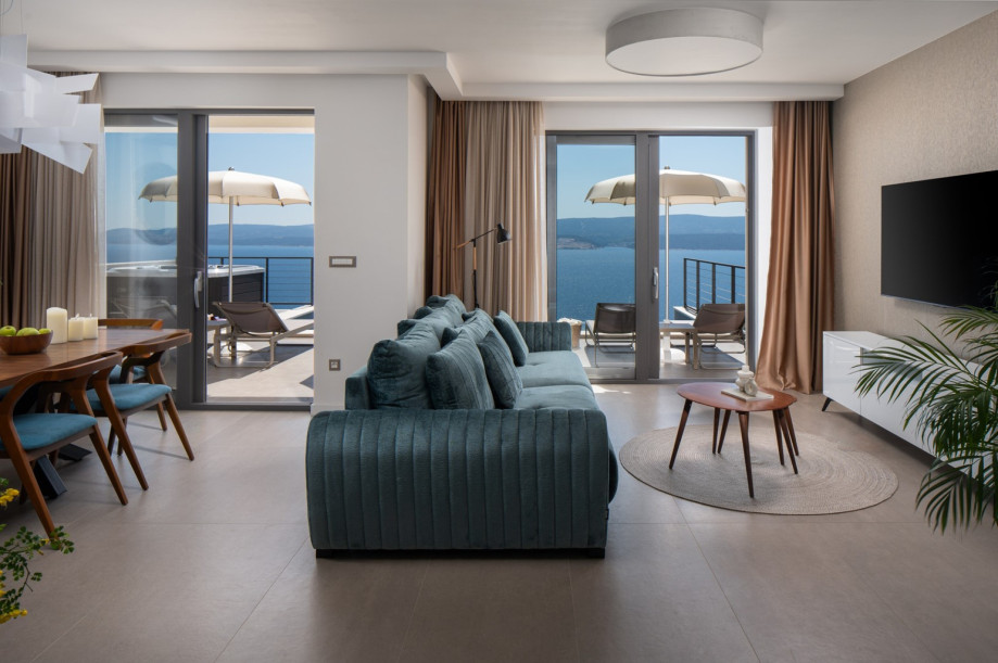 The ground floor offers a stylish open-plan living room, dining area, and fully equipped kitchen