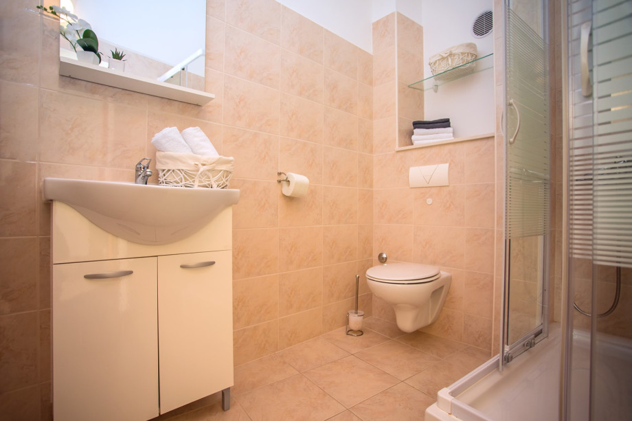 Bathroom on the first floor, there is one more equal bathroom on this floor